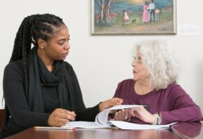 social worker talking to elderly client